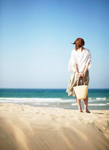 Woman on Beach Looking at Ocean